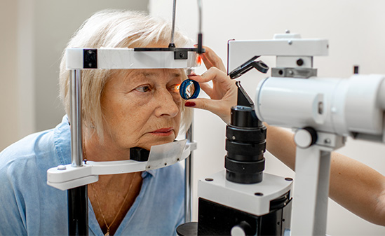 An image of an elderly woman receiving an eye exam.