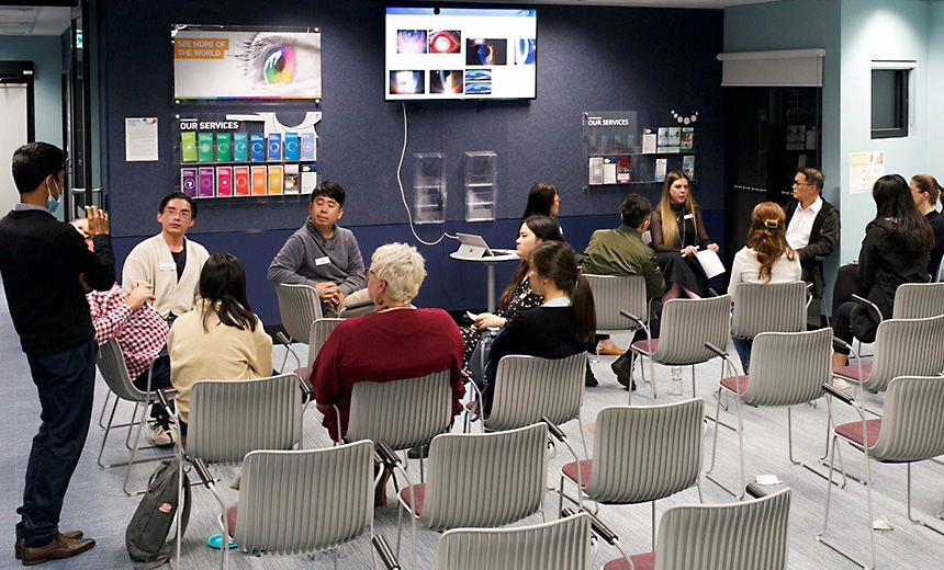 Two small groups of optometrists sit in circles at the Vision Eye Institute Brisbane clinic to discuss cataract co-management.