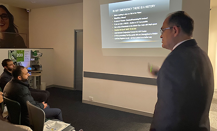 Dr Uday Bhatt presents to attendees at Specsavers Knox City. The Powerpoint slide on the screen isn't legible in the photo, other than the title, which says, 'In any emergency there is a history'.