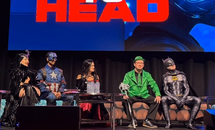 Dr Lewis Levitz, dressed as The Riddler from The Batman movies, on stage during the head-to-head debate session at the 2025 Australasian Society of Cataract and Refractive Surgeons (AUSCRS) conference in Darwin, Australia. He is surrounded by three individuals, also dressed as superheroes and villains.