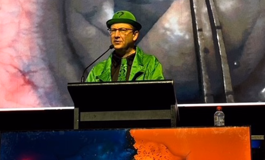 Dr Lewis Levitz, dressed as The Riddler from The Batman movies, speaking at the podium while on stage during the head-to-head debate session at the 2025 Australasian Society of Cataract and Refractive Surgeons (AUSCRS) conference in Darwin, Australia.