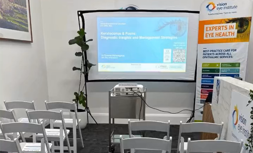 Empty chairs in front of a projector screen set up for a CPD presentations