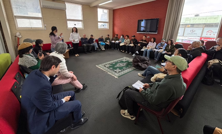 Sasha Kairouz and Kathryn Rizk presenting in front of a group of people who are seating, forming a circle.