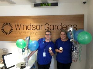Wendy Trestrail and Lisa Rathbone holding cupcakes and balloons
