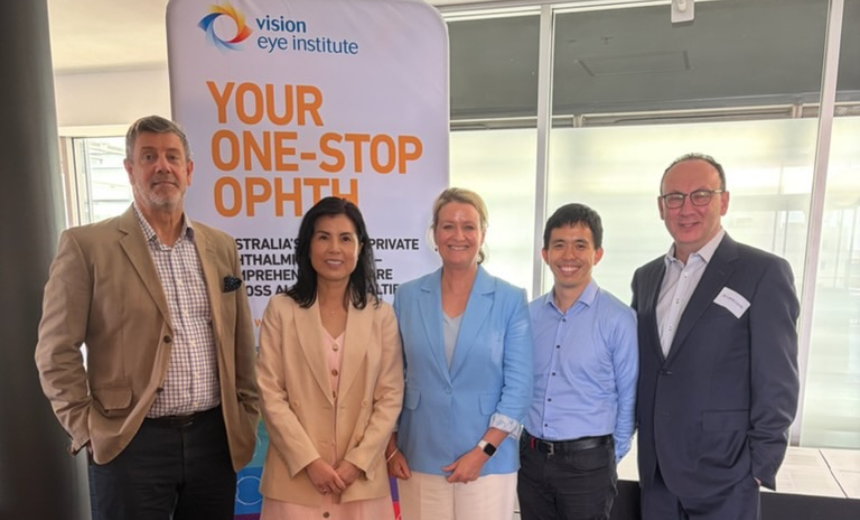 Left to right: A/Prof Tim Roberts, Dr Tess Huynh, VEI CEO Amanda Cranage, Dr Chris Go and Dr Lewis Levitz. They are standing shoulder-to-shoulder, and are positioned in front of a VEI sight that reads 'Your one-stop ophth.'