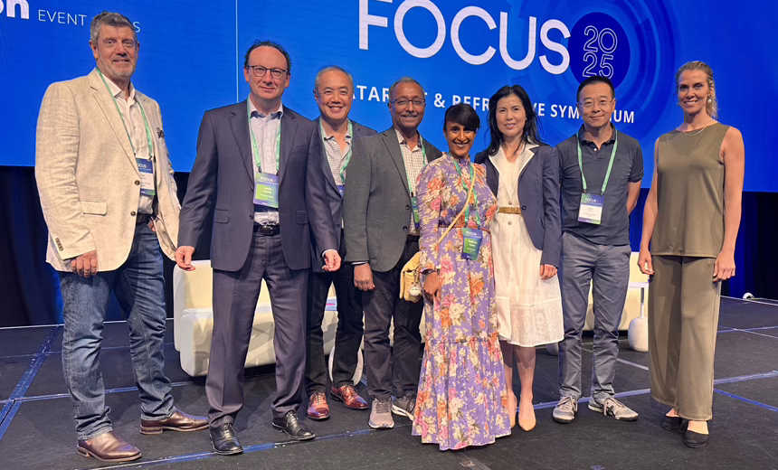 A photo of eight Vision Eye Institute doctors on stage at the Alcon meeting.