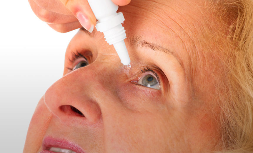 Senior woman putting in eye drops for glaucoma