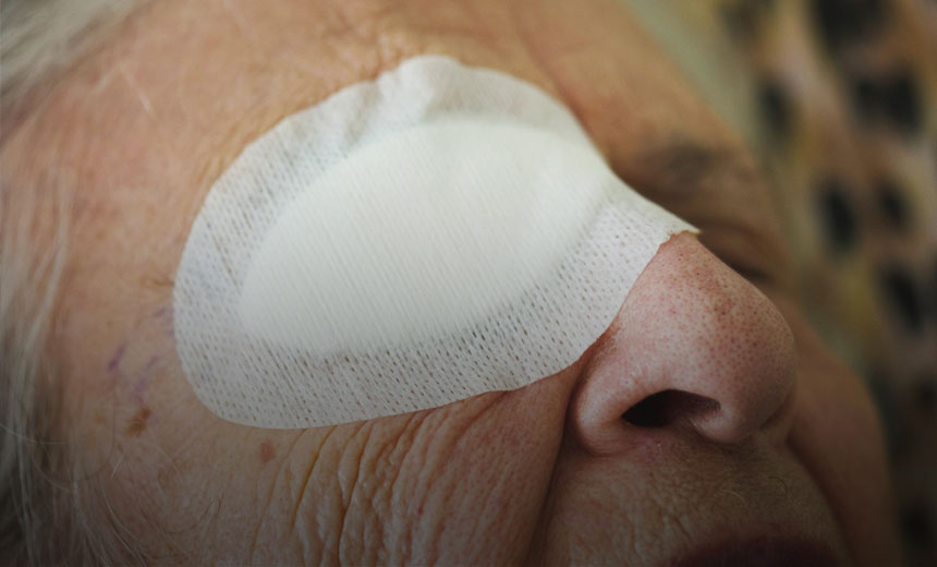 Close-up image of elderly woman with bandage over right eye