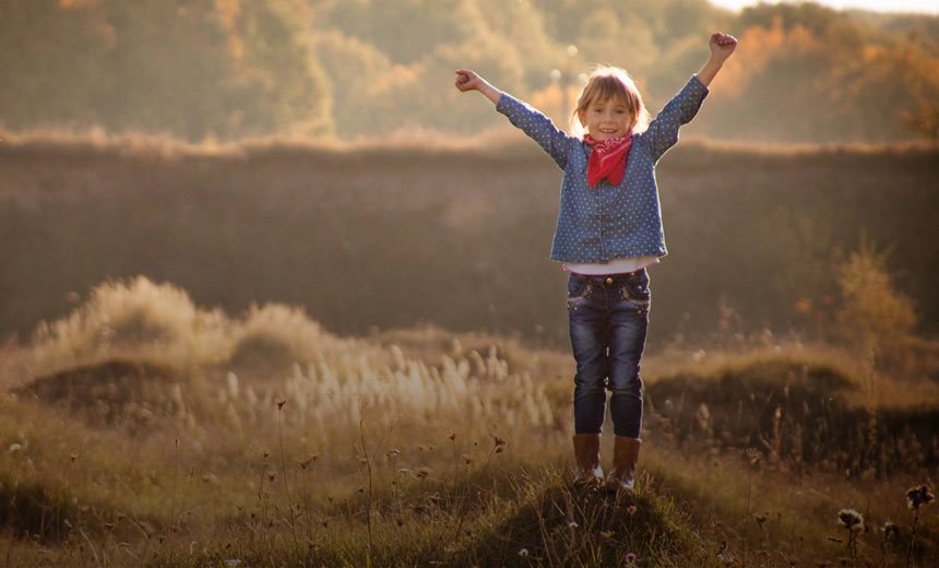 Young blonde girl in nature and sunlight