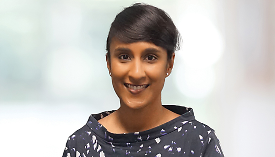 Dr Rushmia Karim headshot indoors; female doctor wearing black floral blouse